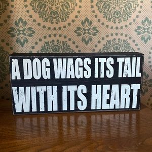 “A dog wags its tail with its heart” sign